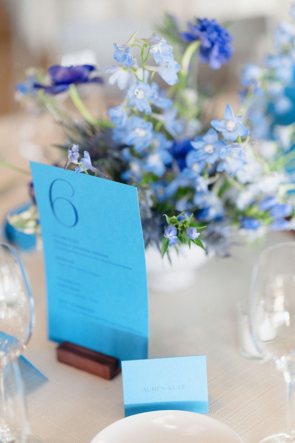 A wildflower wedding at T Lazy 7 Ranch, Aspen: delphinium and anemones beside a bright blue table number