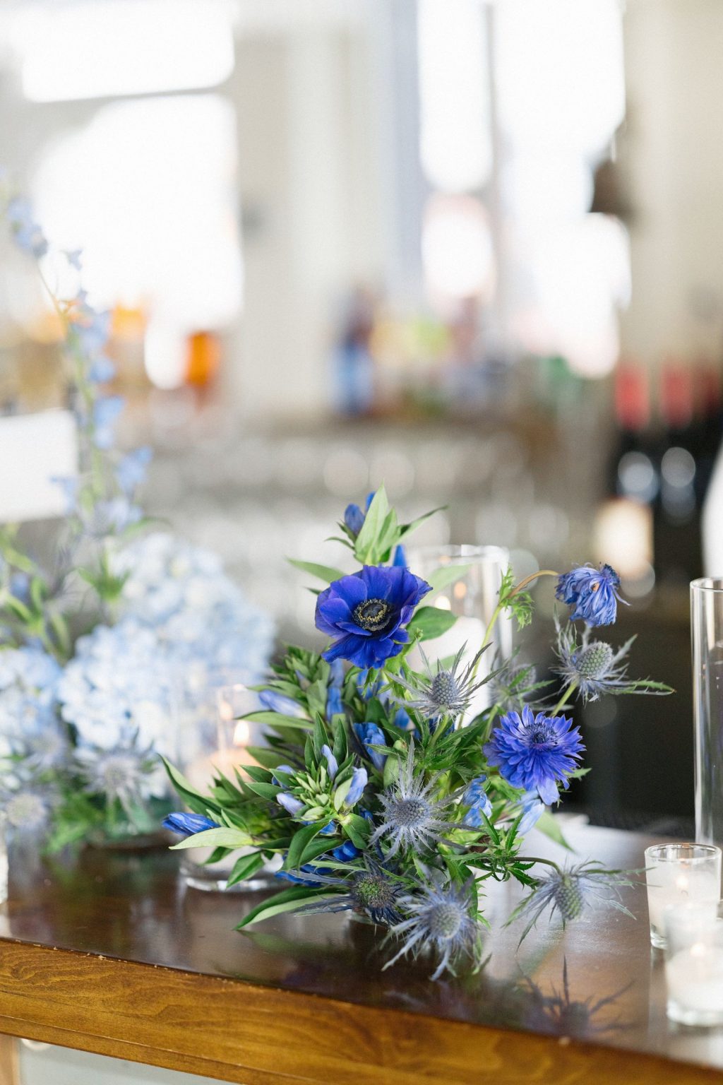 A wildflower wedding at T Lazy 7 Ranch, Aspen: anemones, thistle, and hydrangea on a timber table