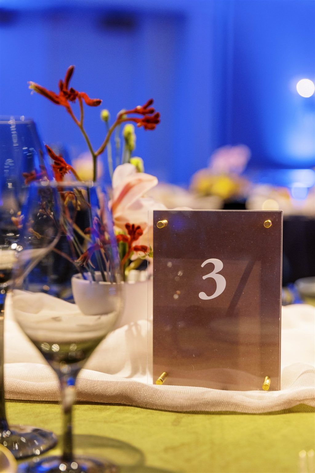 WIPA Colorado Gala in Aspen: table number and florals under blue light